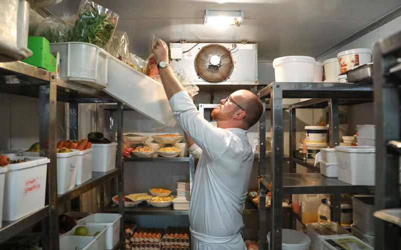 chef getting ingredients from walk-in cooler