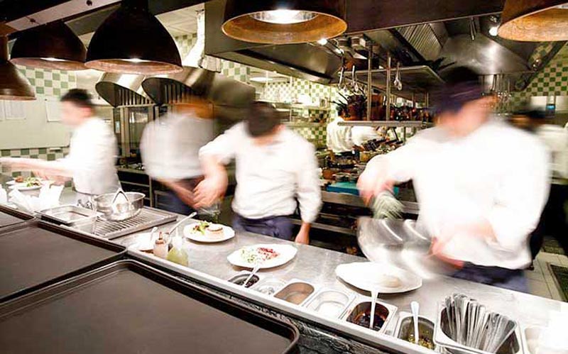 group of chefs on the line in restaurant