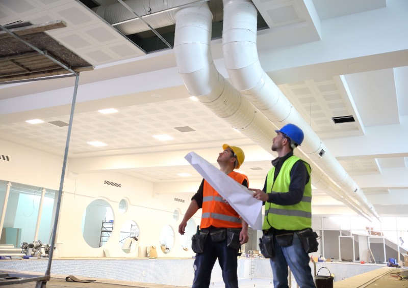 Two engineers focused on sizing a commercial HVAC system in a large office in DuPage County, IL